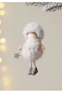 Detail view of a plush angel Christmas ornament with sequin stars on a snowy pine branch