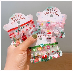 Close-up of handmade Christmas beaded bracelets with Santa Claus and reindeer charms