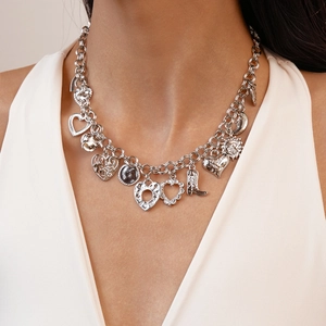 Silver geometric necklace with heart and boot charms on thick chain worn by model