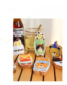 Detailed view of animal-themed wooden bottle openers on a rustic tabletop setting