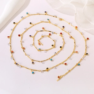 Elegant gold chain necklace with colorful round beads and crystals in spiral layout