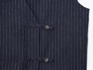 Detail of navy blue striped linen fabric featuring traditional Chinese button loop closure