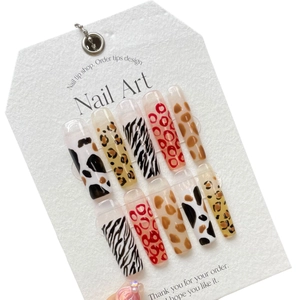 Extra long coffin press-on nails with mixed animal prints including leopard and cow patterns