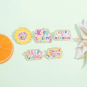 Set of 5 colorful enamel motivational pins with Keep Smiling and Keep Growing slogans