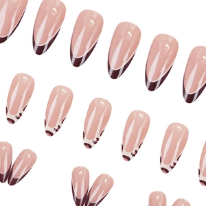 Almond shaped leopard print press-on nails with nude pink base and brown French tips