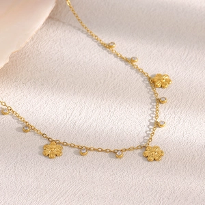 Detail of 18K gold-plated O-chain necklace featuring delicate flower charms and zircons