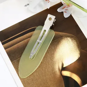 Detail showing an 8cm light green translucent acetate hair clip with a silver metal base