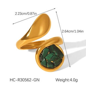 Detail of gold-plated bypass ring featuring a green malachite stone and teardrop metal end