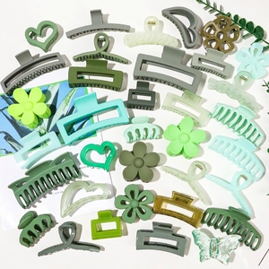Collection of elegant green hair claws in various styles like floral and minimalist shapes
