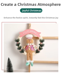 Detail of Christmas wreath with plush gingerbread man and Feliz Navidad pink ribbon