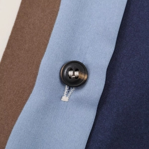 Macro shot of striped satin fabric texture with a premium marble pattern resin button