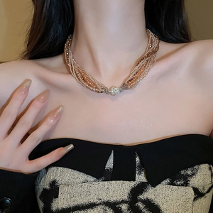 Detail of multi-layer beaded necklace with crystal elements and sparkling diamond clasp