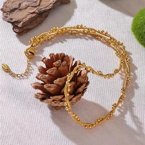 Detail of gold-plated stainless steel snake chain with lobster clasp and S.STEEL tag