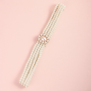 Detail of multi-row pearl waist chain with vintage gold buckle and sparkling rhinestones