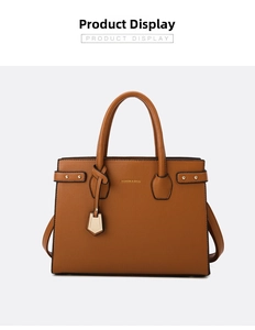 Detail of brown litchi pattern PU leather handbag with gold Fashion and Bags lettering