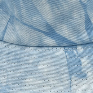 Macro detail of blue and white tie-dye cotton bucket hat with reinforced stitching