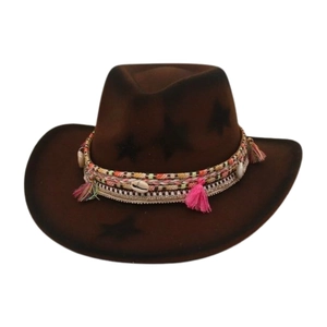 Detail of dark brown cowboy hat with pink tassels, shells, and star patterns