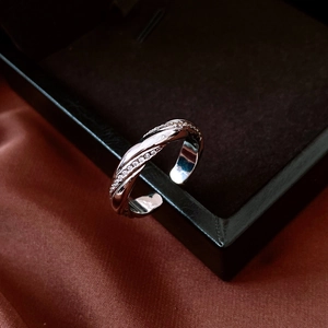 Macro shot of silver twisted ring featuring micro-pave cubic zirconia on black leather
