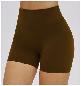 Detail of high-waisted olive green yoga shorts with flatlock stitching and firm fabric