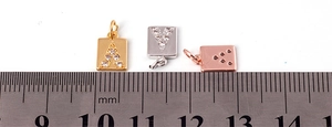 Close-up of 10mm micro-pave letter charms in gold, silver and rose gold with scale
