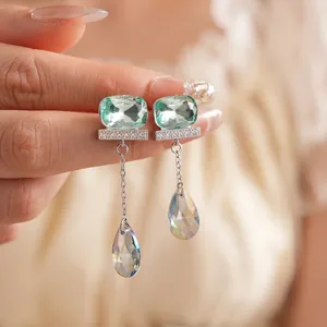 Silver drop earrings with green emerald-cut stones and iridescent crystal tassels