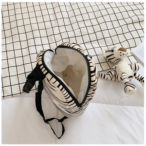 Detailed interior view of a zebra-striped kids backpack with black adjustable straps