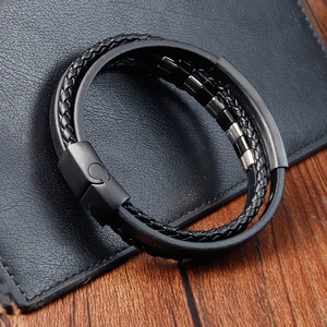 Men's double-layer braided black leather bracelet with steel beads on a leather wallet