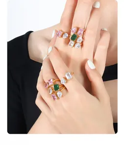 Detail of stacked gold-plated titanium rings featuring colorful zircon gemstones in various cuts
