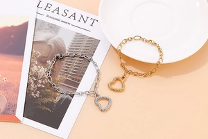 Detail of fashion hollow heart pendant bracelets in gold and silver stainless steel