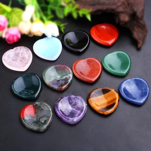 Natural heart-shaped healing thumb stones in various colorful polished crystals and gems