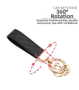 Detail of black quilted leather car keychain with a 360-degree rotating gold metal ring