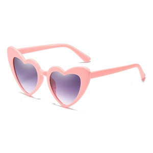 Fashionable heart-shaped pink sunglasses with purple gradient lenses from a 45-degree angle