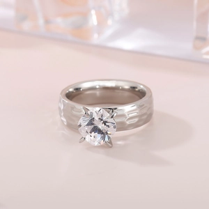 Close-up of a silver four-prong diamond ring with a unique hammered texture on a 6mm band