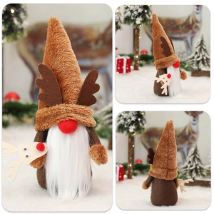 Christmas plush gnome with reindeer antlers and long white beard on snowy background