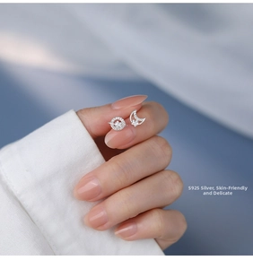 Detail showing asymmetric S925 sterling silver planet and moon stud earrings with zircons