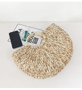 Close-up of woven straw handbag texture with round handle and lifestyle accessories