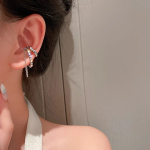 Detail view of silver layered butterfly ear cuff with sparkling stones and chain fringe