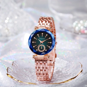 Luxury rose gold women's quartz watch with blue faceted bezel and green gradient dial