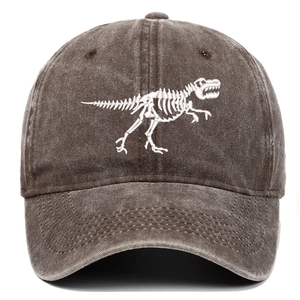 Detailed close-up of white dinosaur skeleton embroidery on washed dark grey cotton baseball cap
