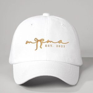 White baseball cap with gold Mama EST 2025 embroidery and stylish bow design details