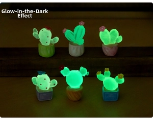 Close-up of luminous miniature cactus figurines showing green glow in the dark