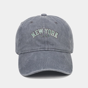 Detail of grey washed cotton baseball cap with New York embroidery and curved brim