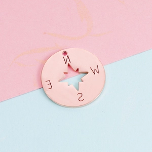 Detailed view of a 22mm rose gold compass pendant with mirror polish for DIY jewelry