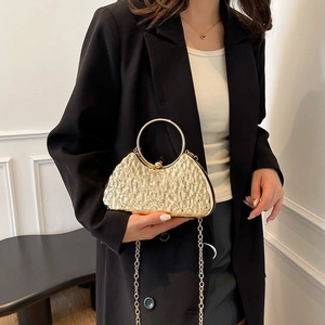 Elegant gold evening clutch with hammered metal texture, ring handle and chain strap