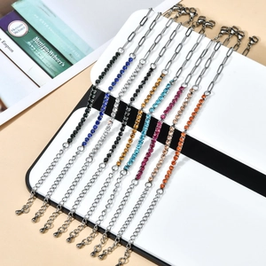 Detail of colorful rhinestone bracelets on silver paperclip chains with adjustable tail