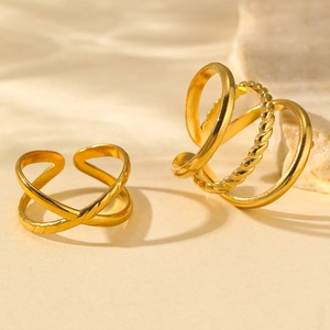 Detail of golden stainless steel rings with hammer finish and twisted rope texture
