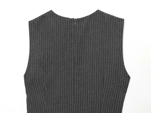 Detail of invisible back zipper on striped midi dress with dark grey vertical patterns