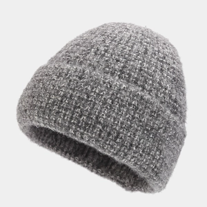 Close-up of thick dark grey cable knit beanie showing warm wool blend texture and details