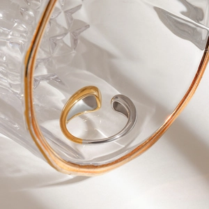 Detailed view of bicolor silver and gold stainless steel ring with adjustable band
