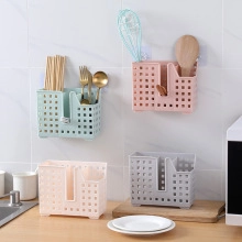 Wall-mounted cutlery holder with drainage holes in light blue, pink, white, and grey